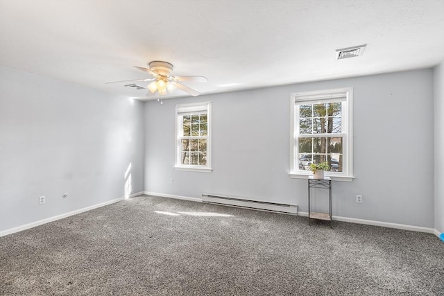 carpeted spare room with a baseboard radiator, a wealth of natural light, and ceiling fan