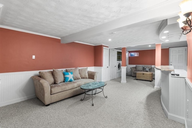 carpeted living room featuring washer / clothes dryer, crown molding, decorative columns, and a textured ceiling