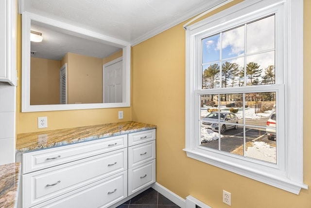 bathroom with vanity, ornamental molding, and tile patterned floors