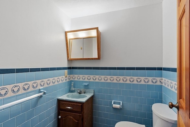 40 Lombard Rd, Hubbardston, MA 01452 - bathroom featuring toilet, tile walls, vanity, and a wainscoted wall