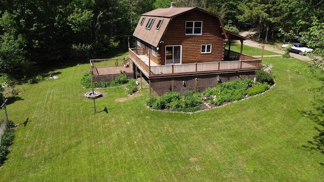 40 Lombard Rd, Hubbardston, MA 01452 - back of property with a gambrel roof, a wooden deck, a lawn, and log siding