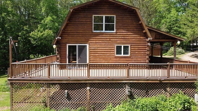 40 Lombard Rd, Hubbardston, MA 01452 - rear view of property with log exterior, a gambrel roof, and a deck