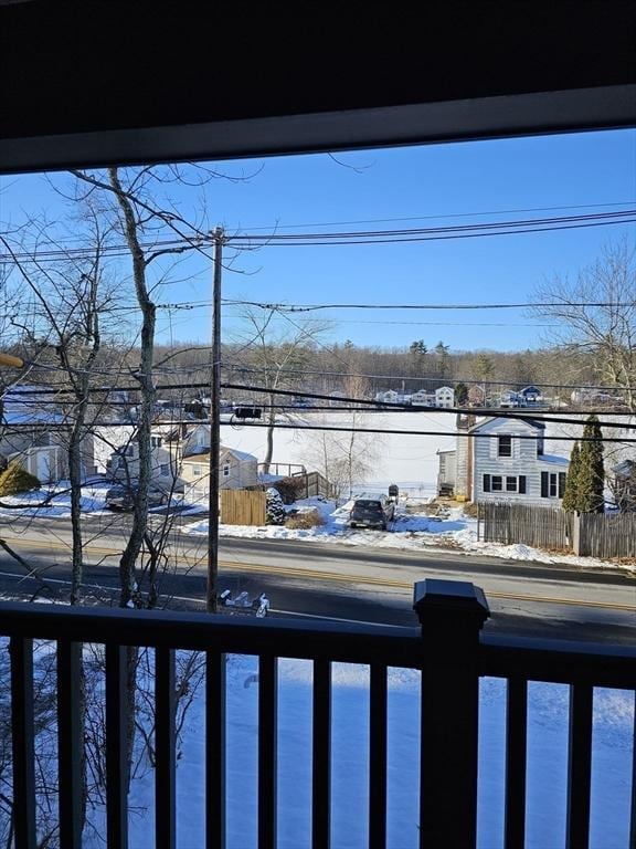 view of snow covered back of property