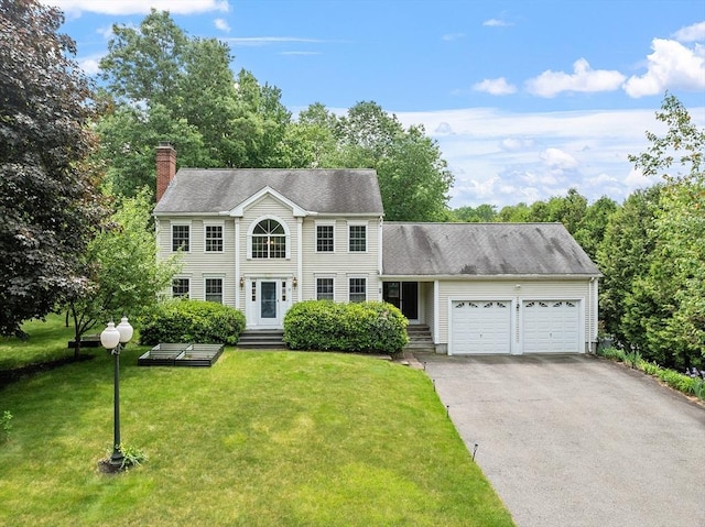 51 Carrie Ann Ln, Fitchburg, MA 01420 - colonial home featuring an attached garage, asphalt driveway, a chimney, and a front yard