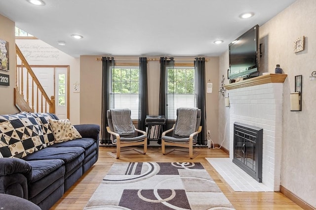 51 Carrie Ann Ln, Fitchburg, MA 01420 - living room featuring light wood-style floors, a fireplace, stairs, and recessed lighting