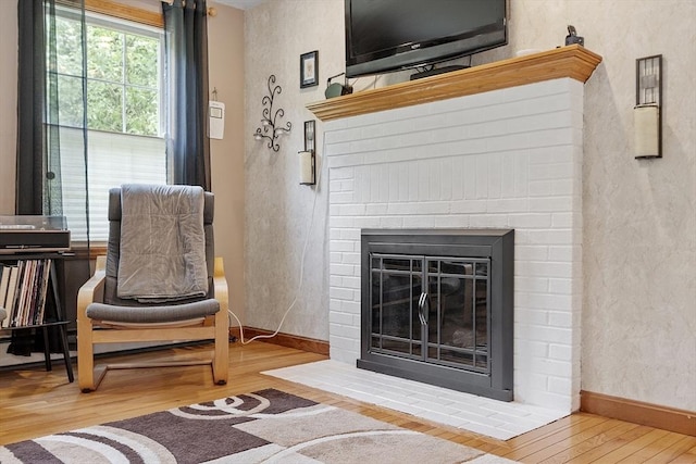 51 Carrie Ann Ln, Fitchburg, MA 01420 - living area featuring wood finished floors, a textured wall, and a brick fireplace