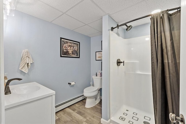 51 Carrie Ann Ln, Fitchburg, MA 01420 - bathroom featuring a baseboard heating unit, wood finished floors, a paneled ceiling, a stall shower, and vanity