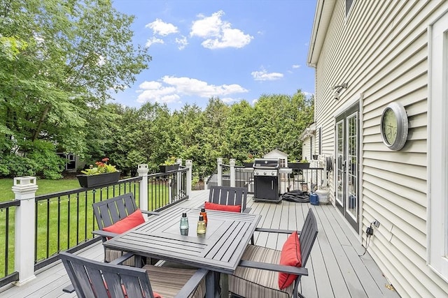 51 Carrie Ann Ln, Fitchburg, MA 01420 - wooden terrace featuring outdoor dining area, a yard, and view of wooded area