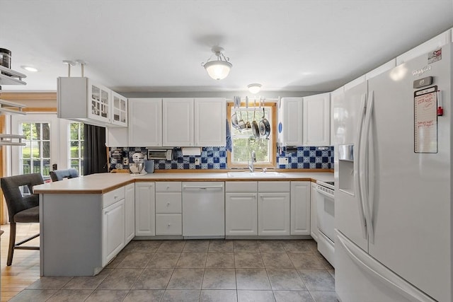 51 Carrie Ann Ln, Fitchburg, MA 01420 - kitchen featuring white appliances, white cabinetry, a peninsula, glass insert cabinets, and recessed lighting
