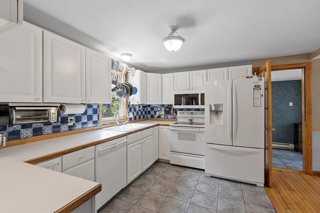 51 Carrie Ann Ln, Fitchburg, MA 01420 - kitchen with white appliances, a baseboard heating unit, white cabinets, backsplash, and light countertops