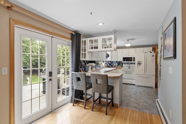 51 Carrie Ann Ln, Fitchburg, MA 01420 - kitchen featuring white appliances, french doors, a peninsula, white cabinets, and glass insert cabinets