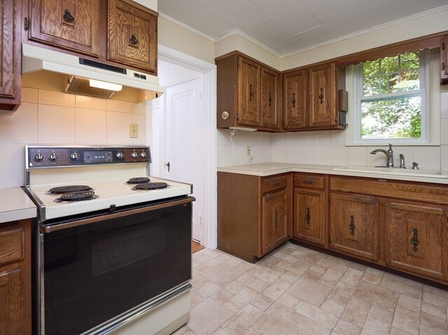 kitchen featuring crown molding, light tile patterned floors, backsplash, electric stove, and sink