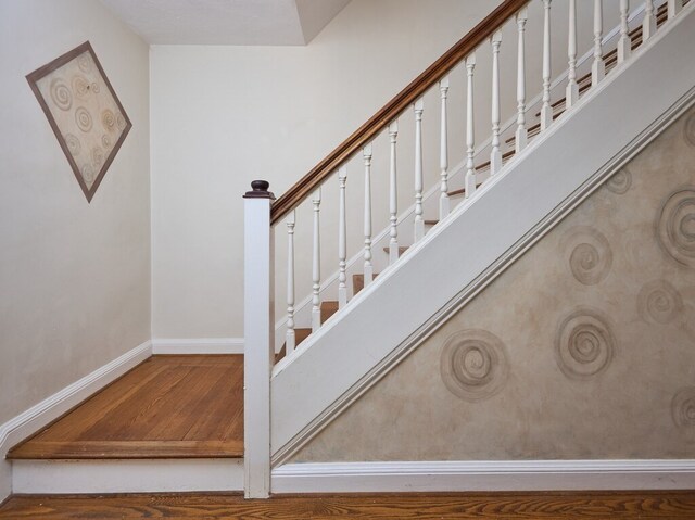 stairs featuring hardwood / wood-style flooring