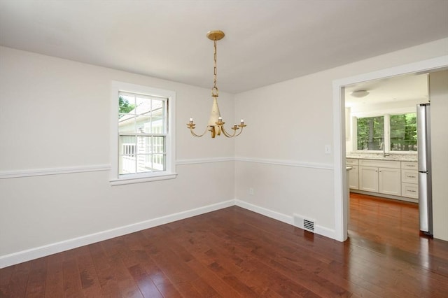 30 Huntley Rd, Hingham, MA 02043 - empty room with a chandelier, healthy amount of natural light, and dark wood finished floors
