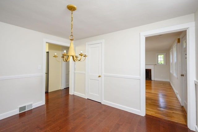 30 Huntley Rd, Hingham, MA 02043 - unfurnished dining area featuring a chandelier, wood finished floors, and a fireplace