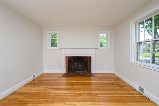 30 Huntley Rd, Hingham, MA 02043 - unfurnished living room with a fireplace with flush hearth, healthy amount of natural light, and light wood finished floors