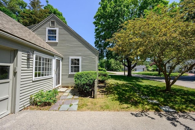 30 Huntley Rd, Hingham, MA 02043 - view of home's exterior with roof with shingles and a lawn