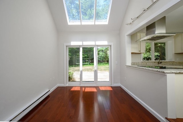 30 Huntley Rd, Hingham, MA 02043 - unfurnished dining area featuring baseboard heating, a skylight, plenty of natural light, dark wood finished floors, and lofted ceiling