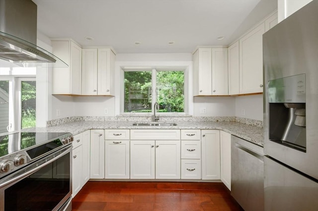 30 Huntley Rd, Hingham, MA 02043 - kitchen with appliances with stainless steel finishes, wall chimney range hood, healthy amount of natural light, white cabinetry, and recessed lighting