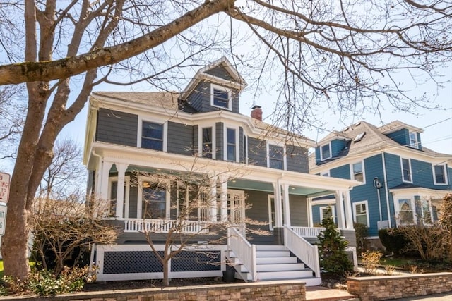 view of front of property with a chimney and a porch
