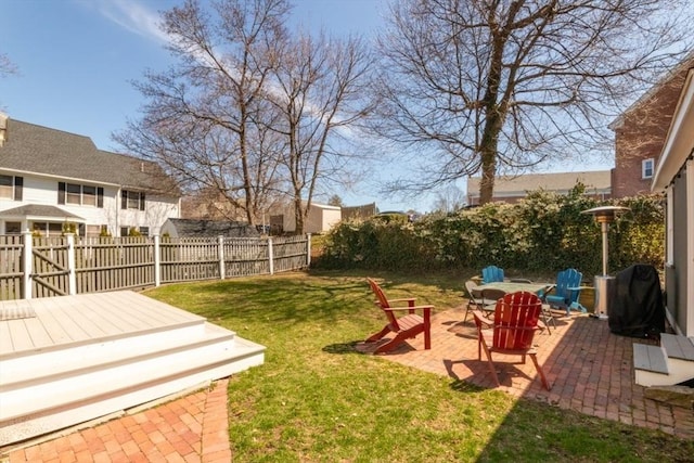 view of yard featuring a patio, a fenced backyard, and a wooden deck