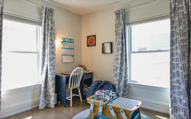 rec room with baseboards and wood finished floors