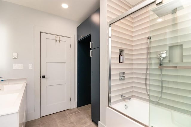 bathroom with recessed lighting, combined bath / shower with glass door, and tile patterned floors