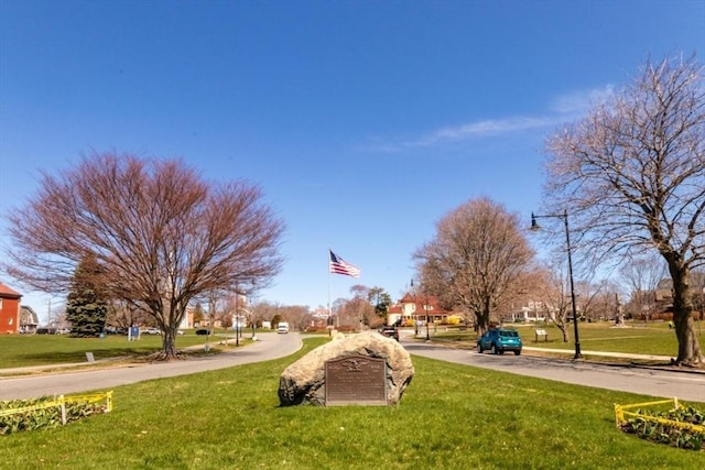 view of property's community with a lawn