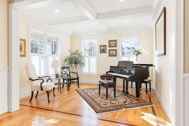 sitting room featuring beam ceiling, coffered ceiling, crown molding, and wood finished floors