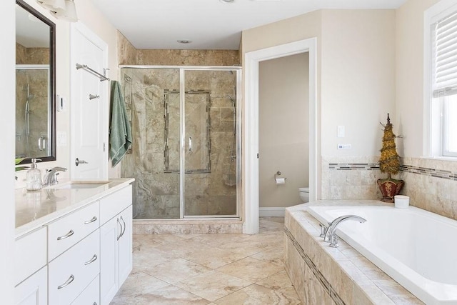 bathroom with vanity, a shower stall, toilet, and a bath