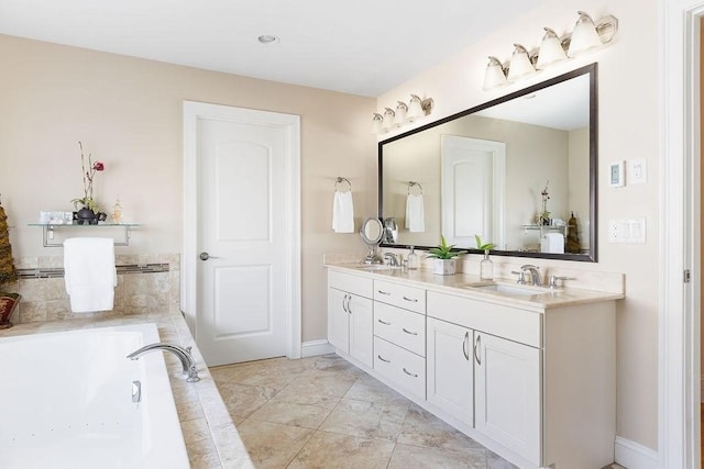 bathroom with baseboards, a sink, a bathing tub, and double vanity