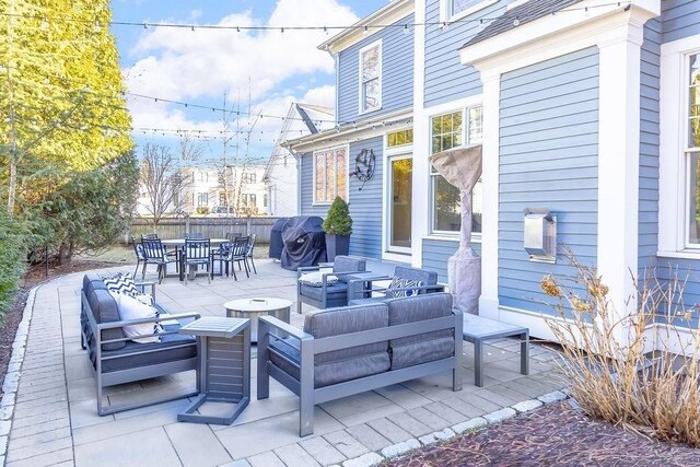 view of patio / terrace featuring outdoor dining space, fence, outdoor lounge area, and area for grilling