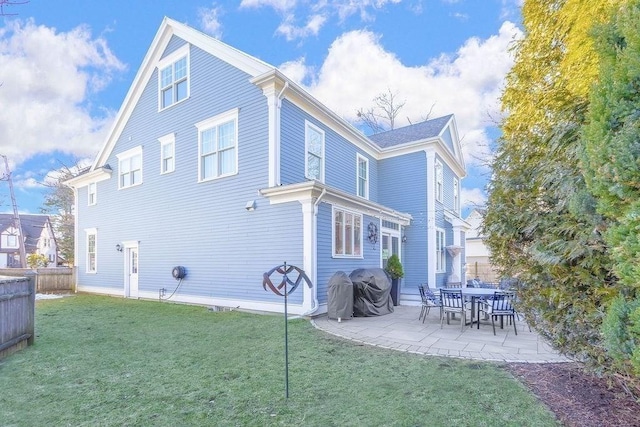 back of house featuring a yard, fence, and a patio