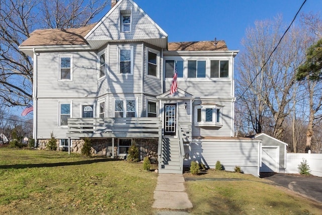 view of front of home with a front yard and a garage