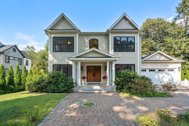 view of front of home featuring an outdoor structure, a garage, and a front lawn