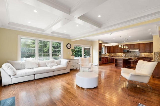 living area with coffered ceiling, ornamental molding, beamed ceiling, wood finished floors, and recessed lighting