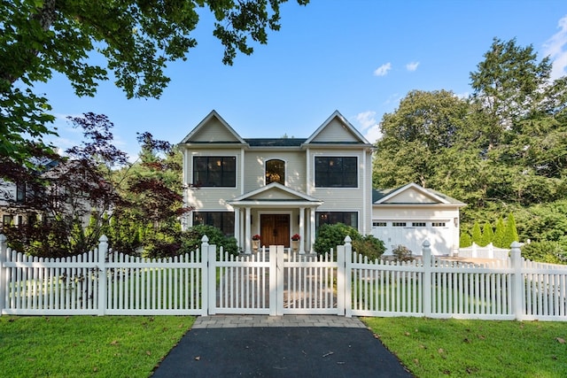 view of front of home with a front lawn and a garage