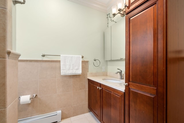 bathroom with vanity, a baseboard radiator, tile walls, tile patterned floors, and crown molding