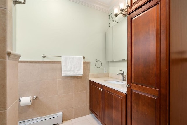 bathroom featuring tile patterned flooring, baseboard heating, crown molding, vanity, and tile walls