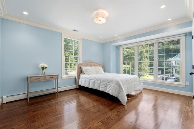 bedroom with hardwood / wood-style floors, crown molding, and multiple windows