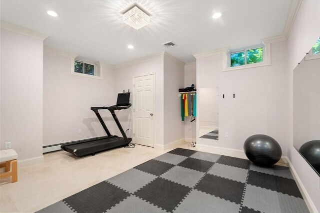 workout room with baseboards and crown molding