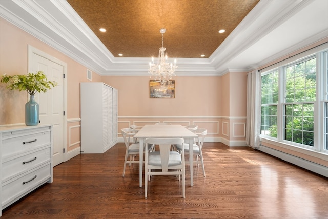 dining room featuring crown molding, wood-type flooring, plenty of natural light, and a tray ceiling