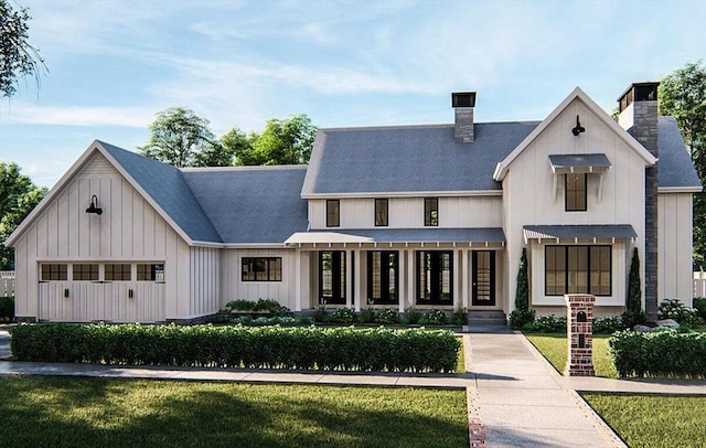 modern farmhouse featuring a front yard and a garage