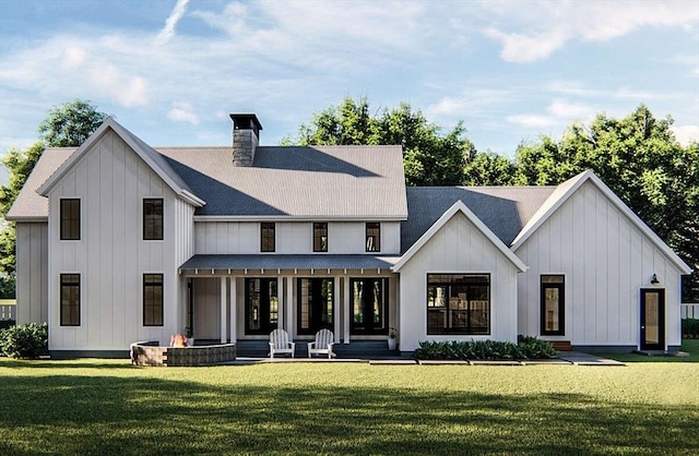 rear view of property featuring a lawn and a porch