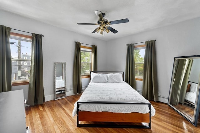 339-341 Norfolk St, Cambridge, MA 02139 - bedroom with multiple windows, light wood finished floors, and a ceiling fan