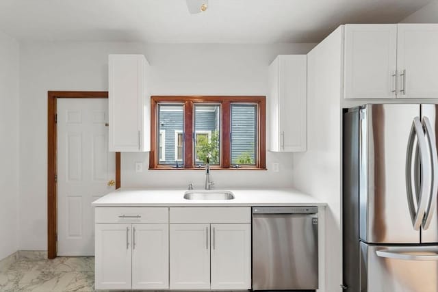339-341 Norfolk St, Cambridge, MA 02139 - kitchen with appliances with stainless steel finishes, a sink, and white cabinetry