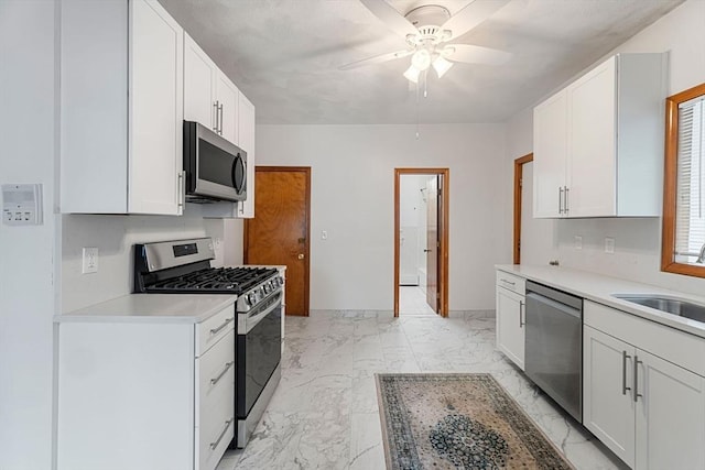 339-341 Norfolk St, Cambridge, MA 02139 - kitchen with appliances with stainless steel finishes, a sink, ceiling fan, light countertops, and light marble finish floors
