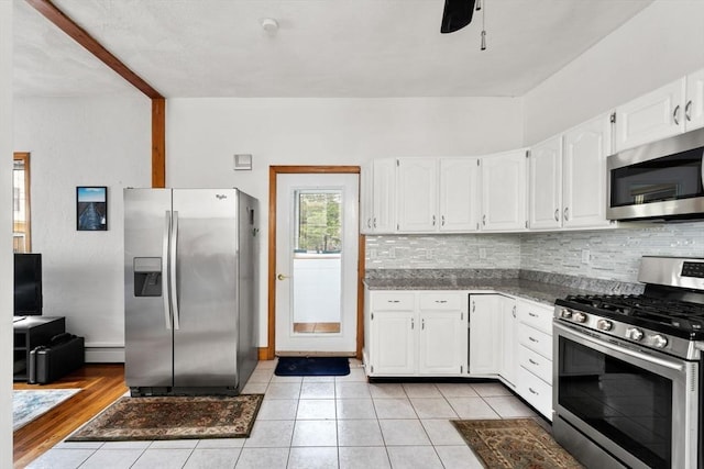 339-341 Norfolk St, Cambridge, MA 02139 - kitchen with appliances with stainless steel finishes, backsplash, white cabinetry, ceiling fan, and light tile patterned flooring