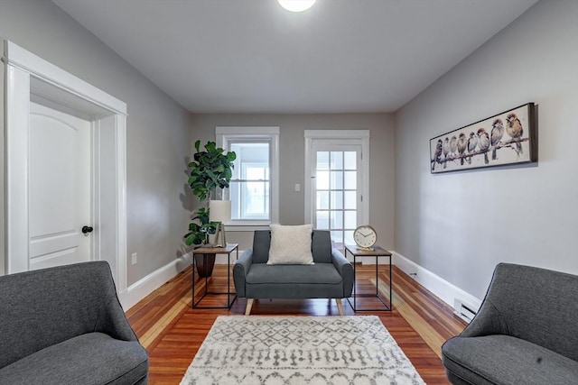 sitting room featuring a baseboard radiator and wood-type flooring