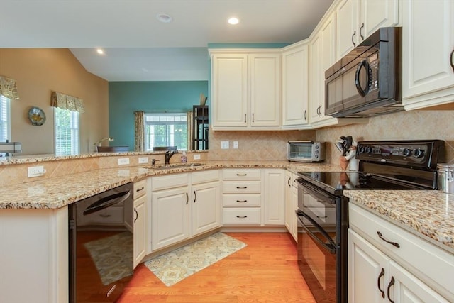 15 Herrick Dr Unit 15, Methuen, MA 01844 - kitchen with black appliances, light wood-style floors, a peninsula, tasteful backsplash, and recessed lighting